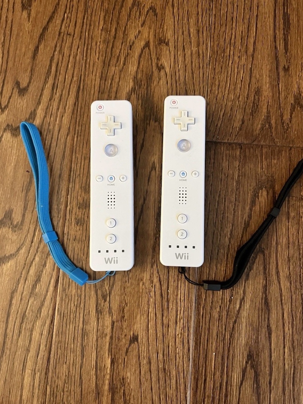 Nintendo White Wii Remote Pair with Blue & Black Wrist Straps